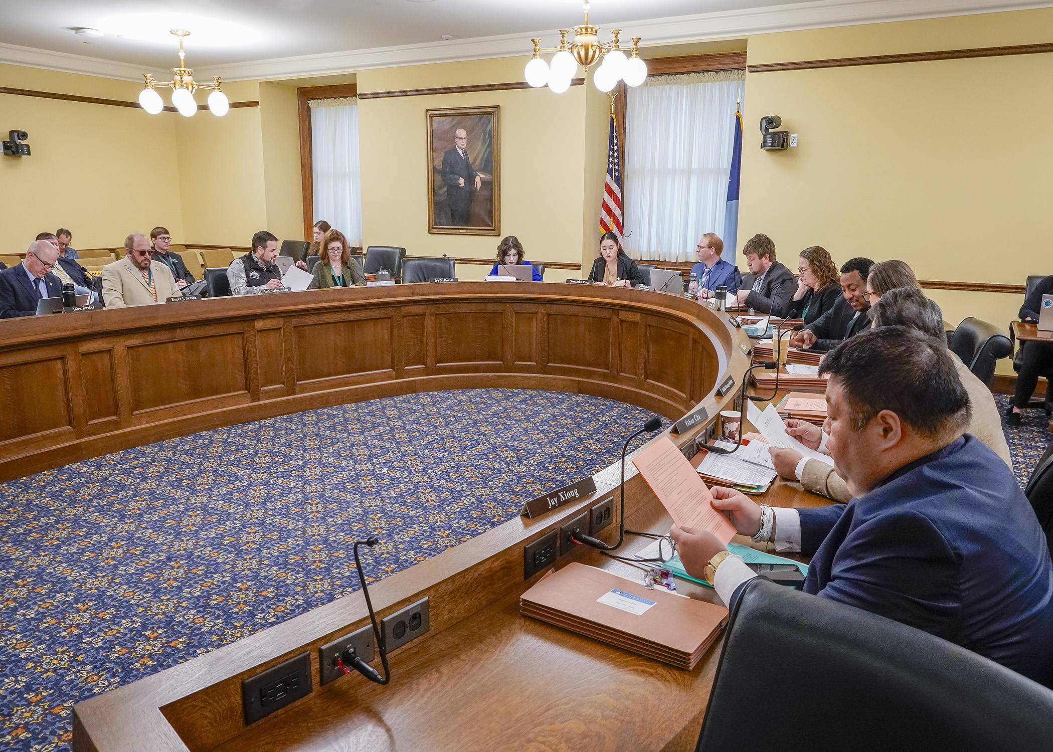 The House Legacy Finance Committee listens April 15 as nonpartisan staff walk through the committee’s finance bill. (Photo by Andrew VonBank)